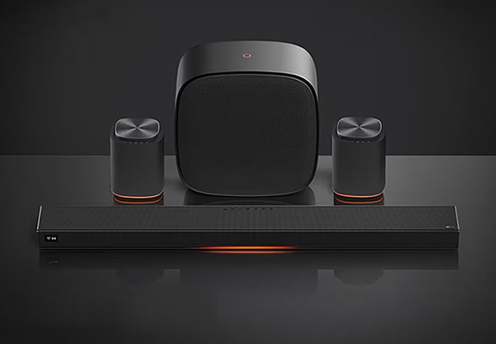 Sound Suite’li LG TV, hoparlörleri ve şık soundbar’ı karanlık bir ortamda sunarak, sürükleyici, yüksek kaliteli ev ses performansını iletir ve aşağıda “Ücretsiz Teslimat” ve “Sıfır Faiz Ödeme” metni görünür.