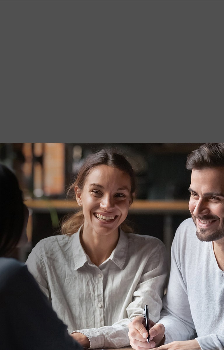 A man and a woman talk to a woman facing each other