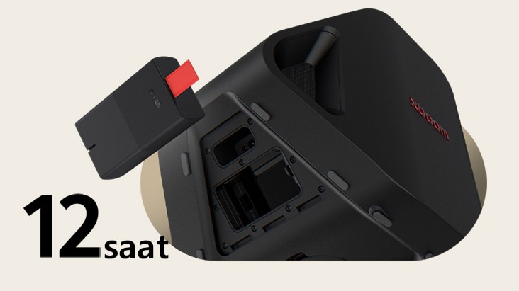 Rear side of Stage 301 is shown with its battert part open. A replaceable battery is hanging on the air right next to the xboom Stage 301.