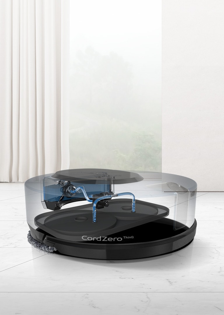 A video shows a see through machine. The water from the tank moves through the tubes to wet the mops which begin to rotate when wet. The CordZero ThinQ logo is shown on the front of the machine. Arrows on either side of the video indicate a carousel.