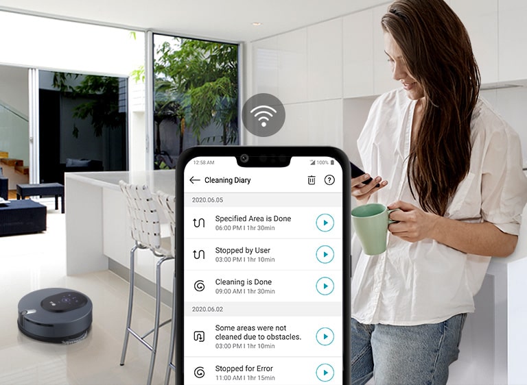 Three icons at the top indicate there are three images in a carousel. The third icon, labelled "Monitoring", is red. A woman stands in a ktichen looking down at her phone with the machine in the background on the floor. A WiFi icon is above a picture of the screen of the phone which shows the LG ThingQ app notifications.