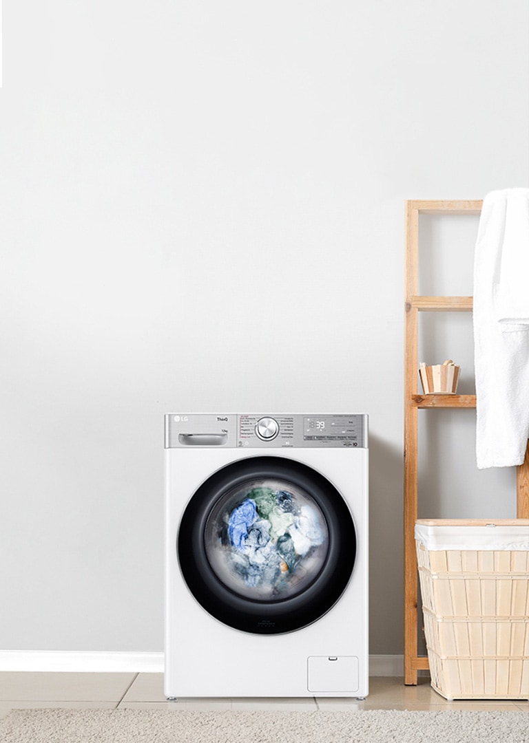 large lg washing machine with full load of washing inside 