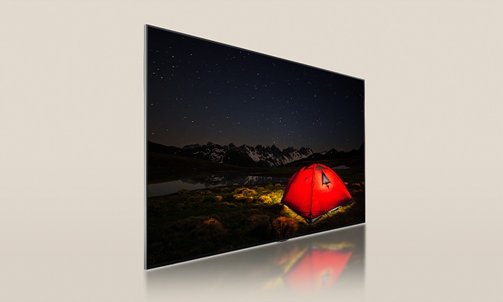 LG TV with a dim screen, displaying a dark night featuring a bright red tent. A blue backlight panel gets divided from behind the TV. Small dimming blocks scatter across the panel. Then, the panel and the TV get merged to make the screen go brighter and clearer.	