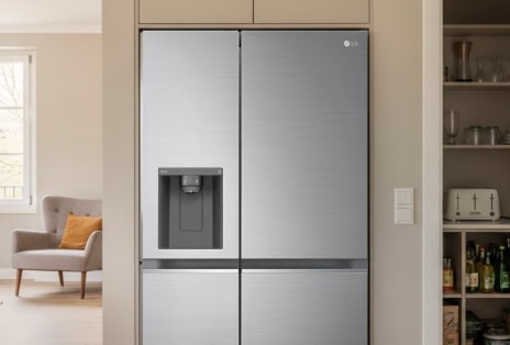 Built-in style LG American fridge freezer in silver finish, seamlessly integrated into a modern kitchen with a warm, neutral-toned interior.