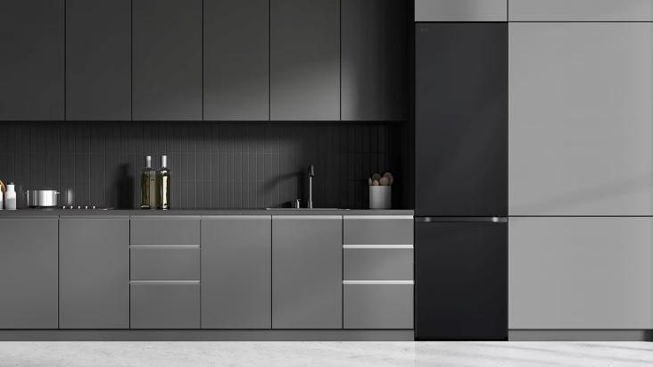 LG's black tall fridge freezer in a sleek, modern grey kitchen with built-in cabinets and minimalist design, offering a seamless and integrated look.