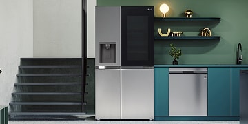 LG InstaView fridge freezer in a stylish green and teal kitchen with open shelving and modern decor, blending premium design with smart functionality.