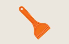 Orange plastic scraper tool.