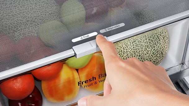 LG refrigerator humidity control drawer with a person adjusting fruit and vegetable setting for optimal freshness