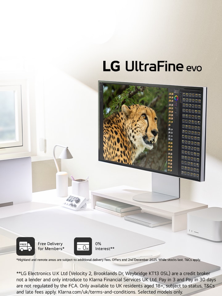 A home office desk setup up with an LG 6K monitor 