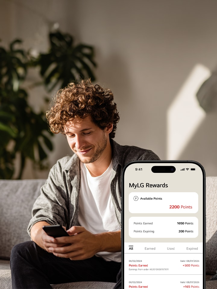 A man and woman look at a phone, with an LG fridge and TV in bubbles on either side