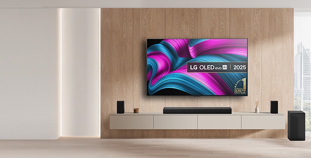 LG oled tv on the wall with a soundbar and speakers and subwoofer underneath with promo message to get a free soundbar when buying pre-set bundles