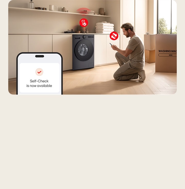 Man installing LG washer in laundry room using phone self check feature with box and folded towels nearby