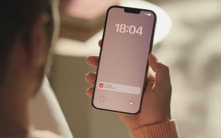 A woman control her LG washing machine from her phone