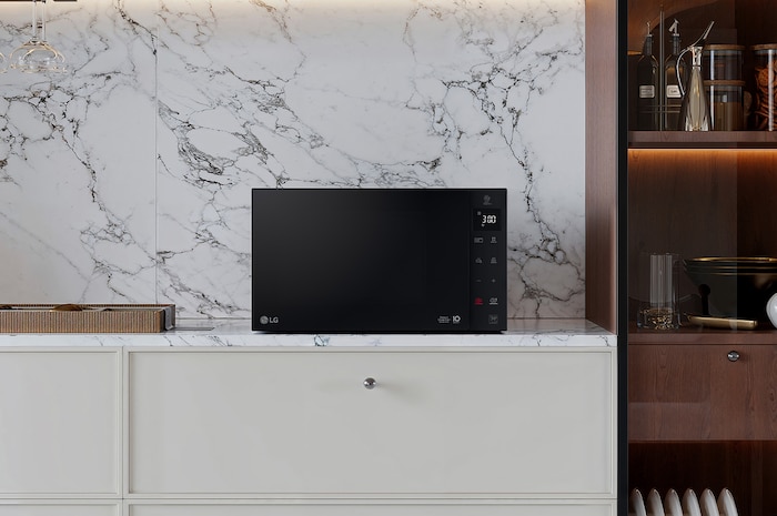 MH6535GIS Grill Microwave on White Counter top with Marble background 