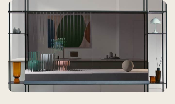 LG SIGNATURE OLED T shows a cat jumping across the transparent screen as it shows the interior space behind simultaneously. Objects are placed to the right and left attachment of the modular shelf. Another transparent TV is placed against the window framing the winter scenery outside the house. On the screen are falling flower petals. Coming back to the LG SIGNATURE OLED T in the first scene, the screen now shows three pottery objects going from blurred lines to the solidified object.