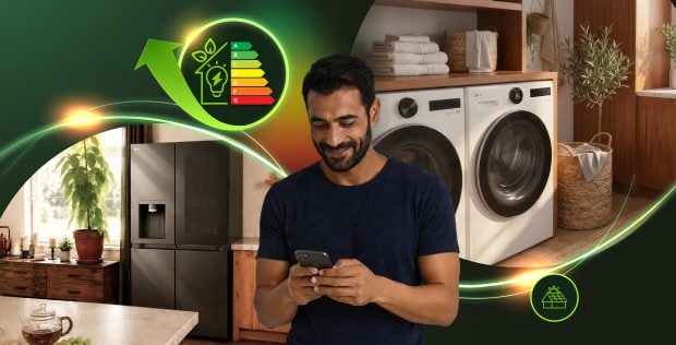 Man using a smartphone in a modern laundry room with LG washer, dryer and refrigerator, surrounded by glowing energy-efficiency graphics.