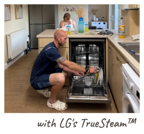 A man kneels on the floor, loading dishes into an open LG dishwasher. [with LG's TrueSteam™]