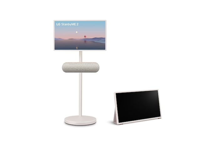 LG StanbyME 2 screens displayed in a modern living room. There is a StanbyME 2 on a stand, one is hung on the wall, and the other is propped up on a table using the folio cover.