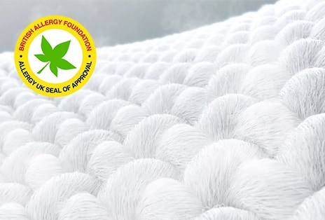 White fabric with visible steam and an Allergy Care mark on the upper left.