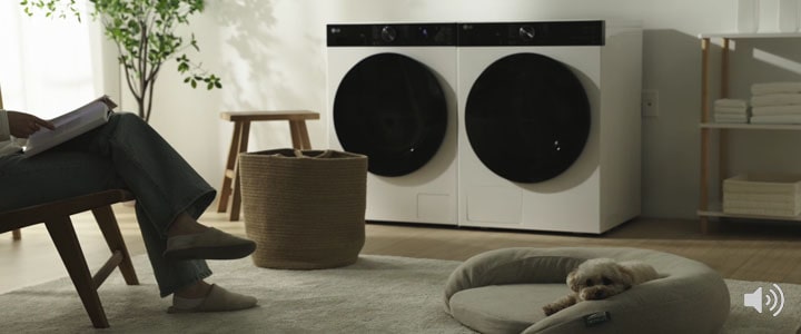 A video of starting the wash cycle, with quiet spinning sounds in the background, while sitting and relaxing with a dog.	