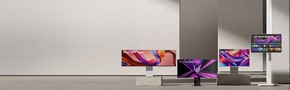 Multiple LG monitors are arranged at different heights and angles, each displaying colorful graphic visuals.