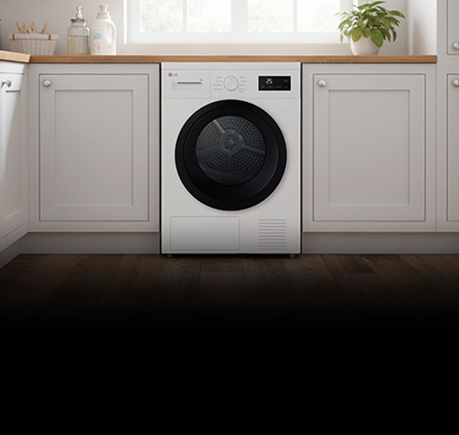 A white front-loading dryer is built into cabinetry, with folded towels visible inside the drum.