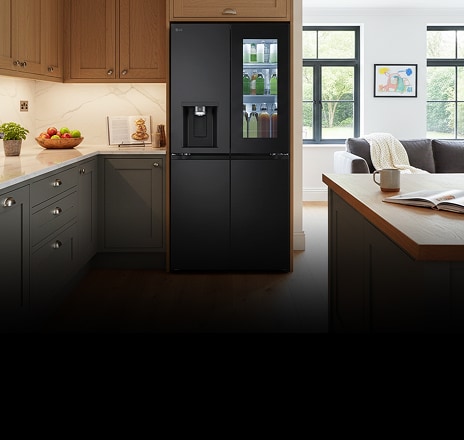 Modern kitchen interior with a black fridge freezer.