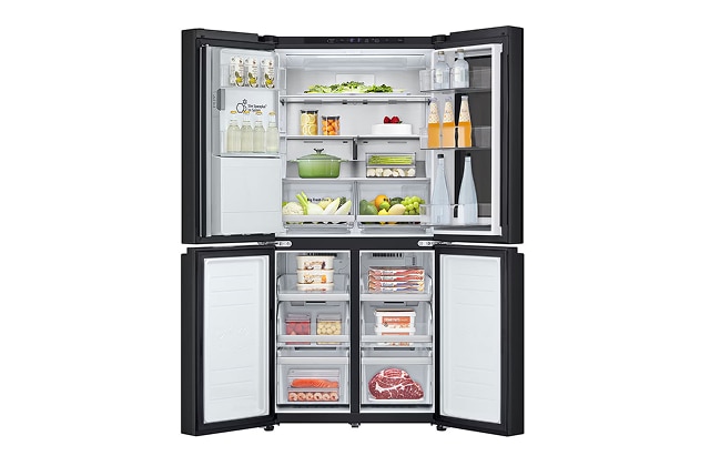 A multi-door refrigerator with the upper fridge and lower freezer compartments open, showing food and drinks arranged on shelves and in drawers.