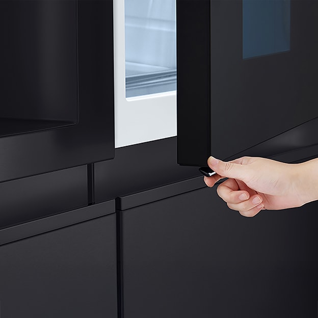 LG refrigerator with the outer door compartment opened and a hand pressing the release button illustrates Door-in-Door quick access storage.