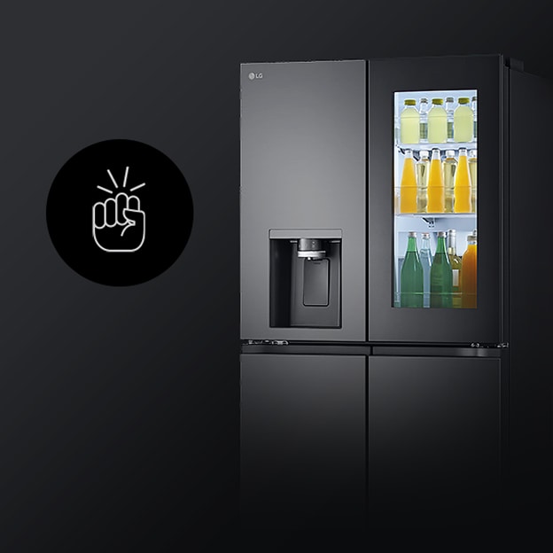 A video shows a woman approaching her InstaView™ refrigerator and knocking twice. The interior lights up, allowing her to see the contents of her refrigerator without opening the door. The view zooms in to focus on the drinks inside the door, then zooms out to show the woman from behind as she opens the door and takes a drink.