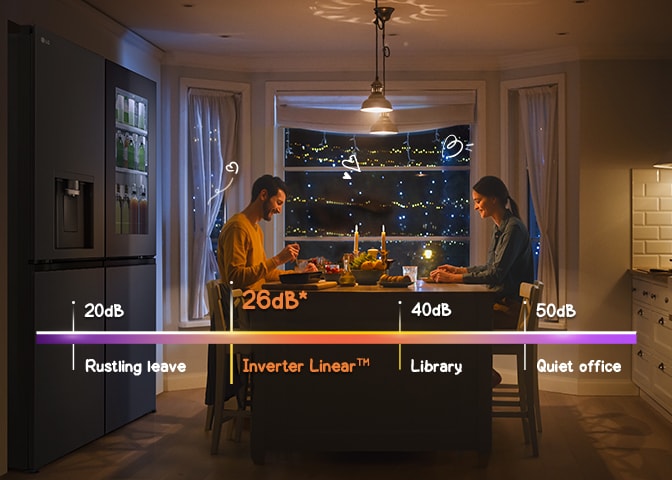 A couple is enjoying a meal in front of a quiet refrigerator.