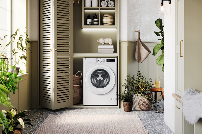 The white LG 8kg/5kg Counter-Depth MAX™ washer-dryer FWY385WWLN1, installed in a stylish, modern laundry closet.