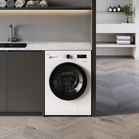 The white LG washer-dryer W4X1085NWK, with 8kg wash and 5kg dry capacity, shown installed under a counter in a modern laundry room.