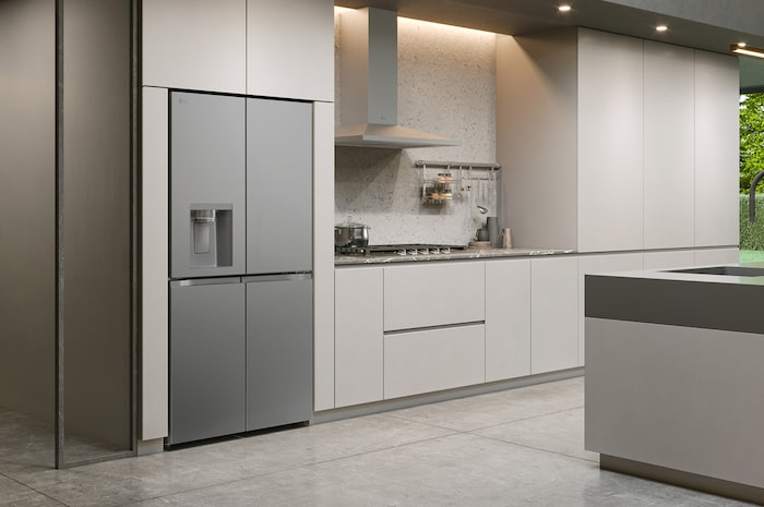 LG Multi-Door Refrigerator GML960PYFE in a silver finish, seamlessly integrated into a modern, minimalist kitchen with light beige cabinets, showcasing its sleek design.