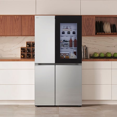 LG Side-by-Side Refrigerator GSVV80PYLL in a stainless steel finish, featuring InstaView™ Door-in-Door®, seamlessly integrated into a modern kitchen with white and wood cabinets.