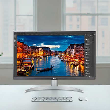 LG Monitor 27UP850K in a white/silver design positioned on a bright desk setup, displaying photo editing software and highlighting the precise and clear 4K picture quality.