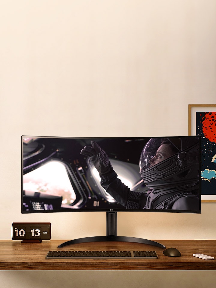 There is a monitor on the desk, and a movie is playing on the monitor screen.