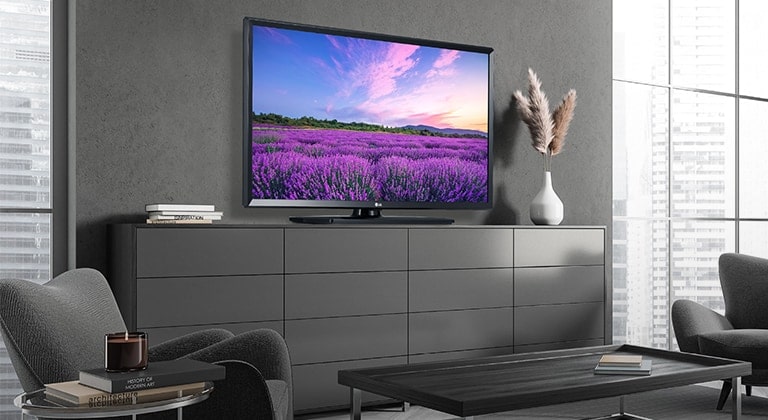 A TV on a hotel’s wall shows a bright and vivid screen.