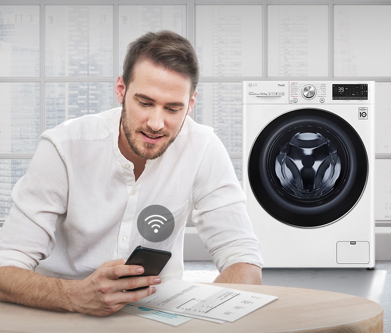 A man outdoors is checking the condition of a washing machine at home through a mobile phone app.