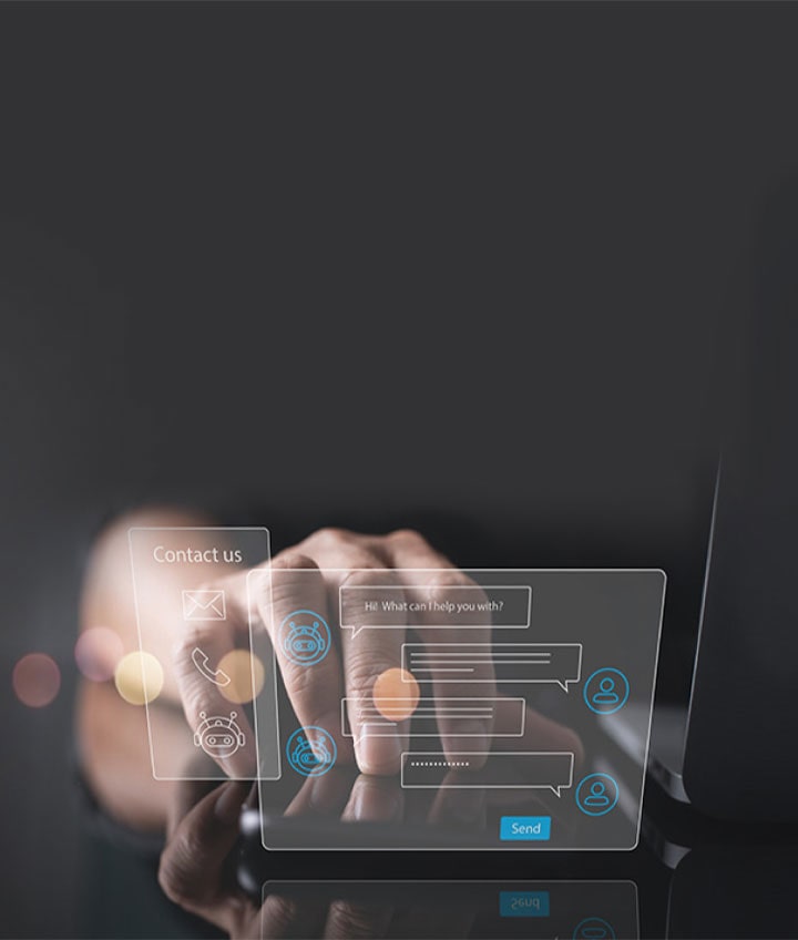 Two virtual hologram windows which are chatting and contact us float next to the laptop and hands are placed behind them.