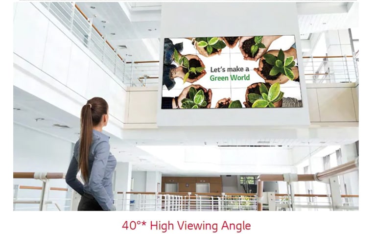 A woman is looking up at the screen installed upstairs.