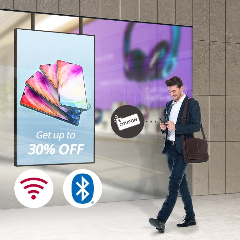 A visitor is receiving promotional coupon in real time through Wi-Fi, Bluetooth, and Beacon built into the display.