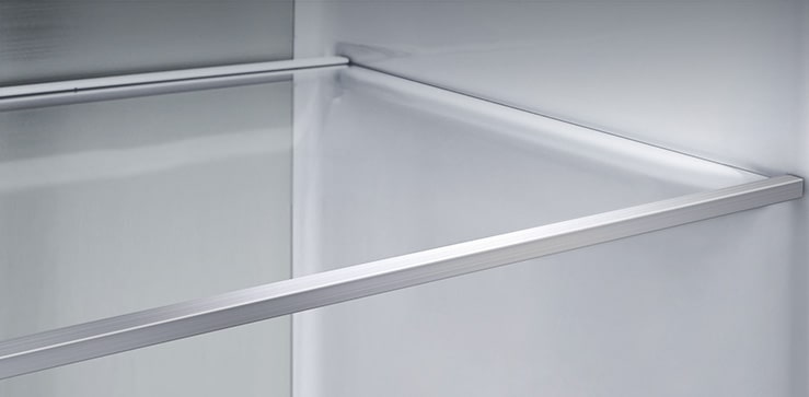 A diagonal view of the shelf with metallic paneling on the interior of the refrigerator.