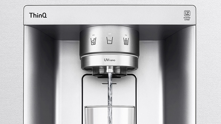 LG ThinQ UVnano water dispenser with water pouring into a glass, featuring touch controls at the top.