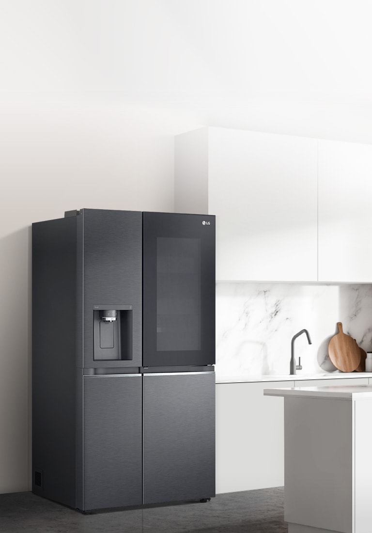 A side view of a kitchen with a black InstaView refrigerator installed.