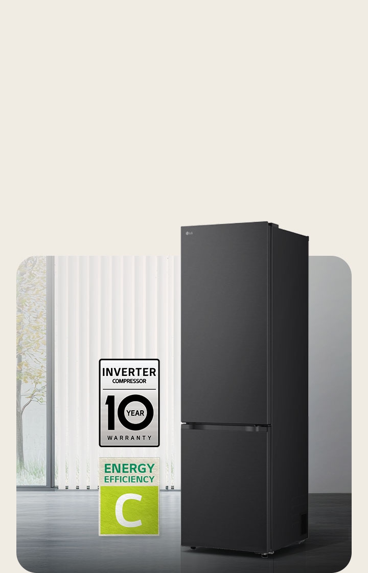 LG bottom freezer (GBBS726CEV) matte black front view in bright room with vertical blinds with 10 year compressor warranty and Energy Efficiency A icons below	