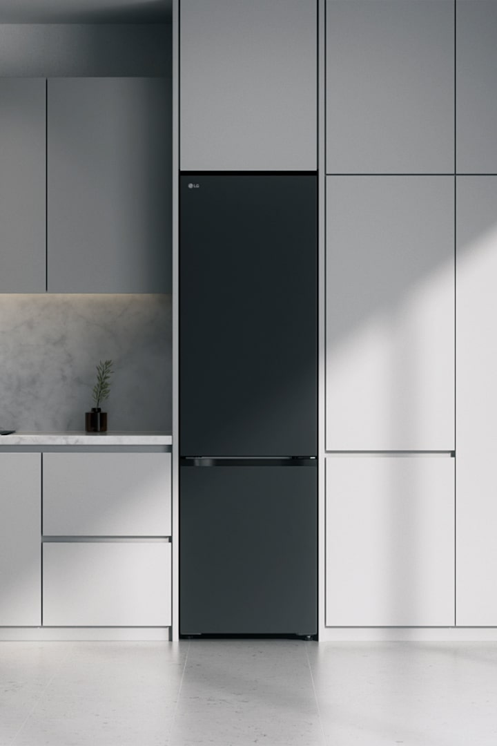 Matte black lg bottom freezer (GBBS726CEV) built into grey cabinets beside marble countertop with induction cooktop and large window on right