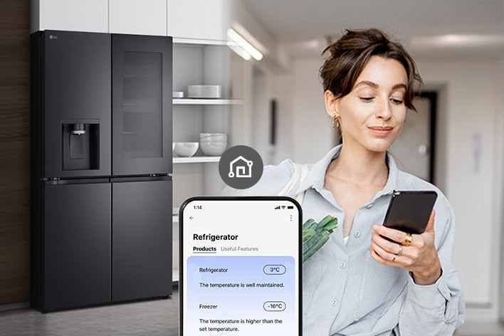 Woman checking refrigerator temperature remotely on her smartphone.	
