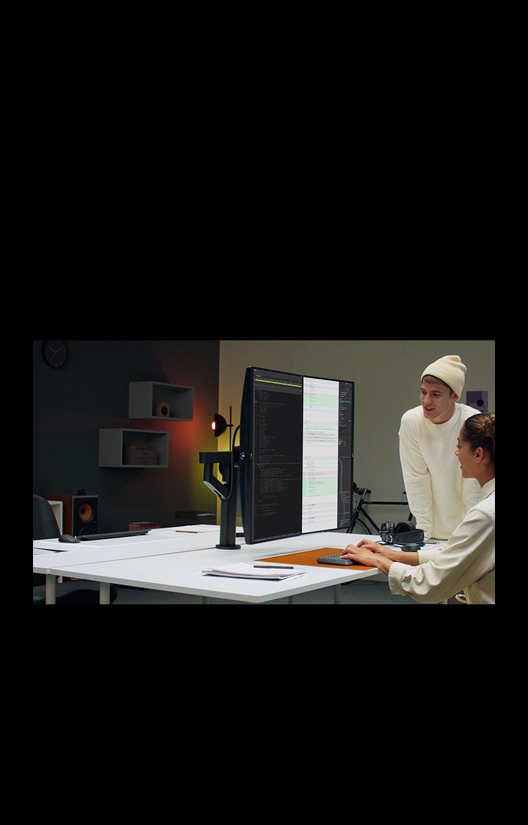 Scene of developer with Ergo Dual monitor