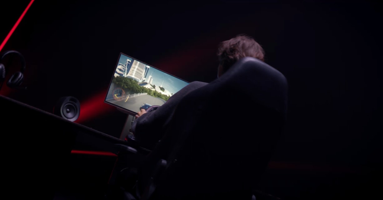 LG UltraGear 27GX790B Product Introduction in a dark background with lazer red lighting effect featuring a man back on a gaming chair along with the monitor